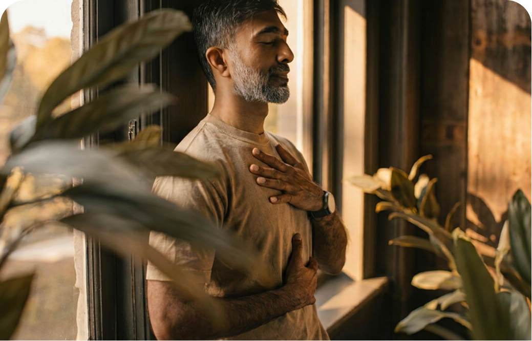Man standing near a bright window in the morning